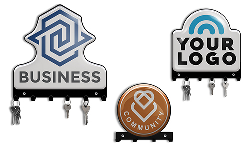 Three key holders with logos: BUSINESS with geometric blue, YOUR LOGO with arc, COMMUNITY with heart, keys hanging
