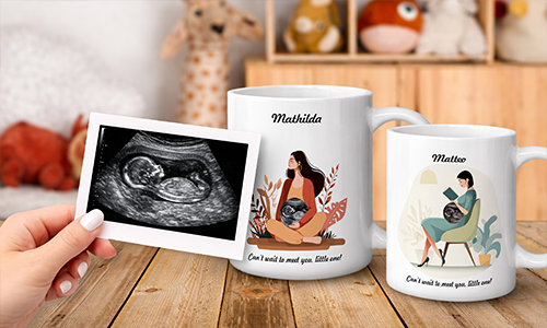 Ultrasound photo held in front of two mugs: Mathilda with foliage, Matteo reading book, baby bump art