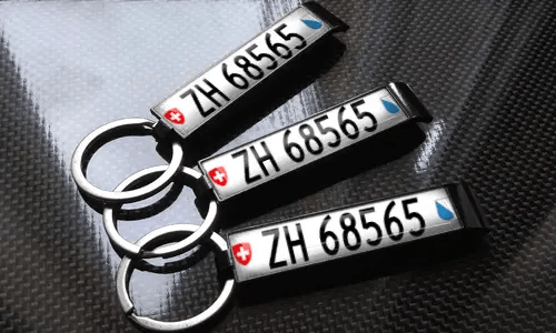 three bottle opener keychains with flags