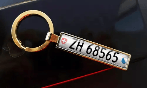 Personalized gold keychain features a custom license plate design