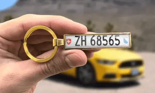 Custom gold keychain displays engraved license plate numbers