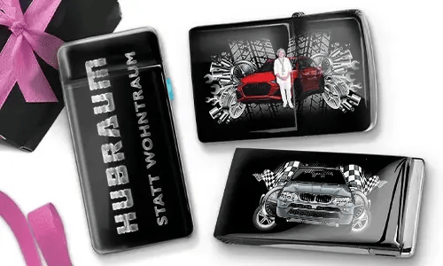 Three black and silver car-themed cigarette cases with dynamic graphics. One reads 
