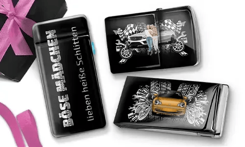 Three shiny black objects with car-themed designs. One reads 