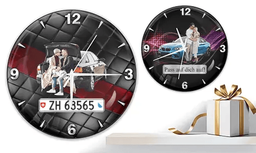 Two wall clocks with family and car scenes: left with trunk picnic on quilted background, right with blue sports car and couple over purple wave
