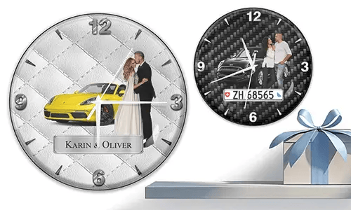 Two wall clocks with formal couple and sports cars: left with yellow car on quilted silver, right with black car on carbon background